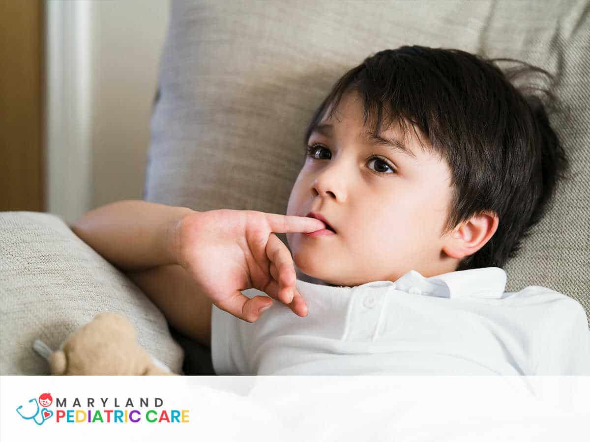 Child putting finger in his mouth.Schoolboy biting his finger nails while  watching TV, Emotional kid portrait, Young boy siting on sofa looking out  with thinking face or nervous, Children Health care Photos |